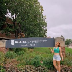 student outside a University building sign in the US